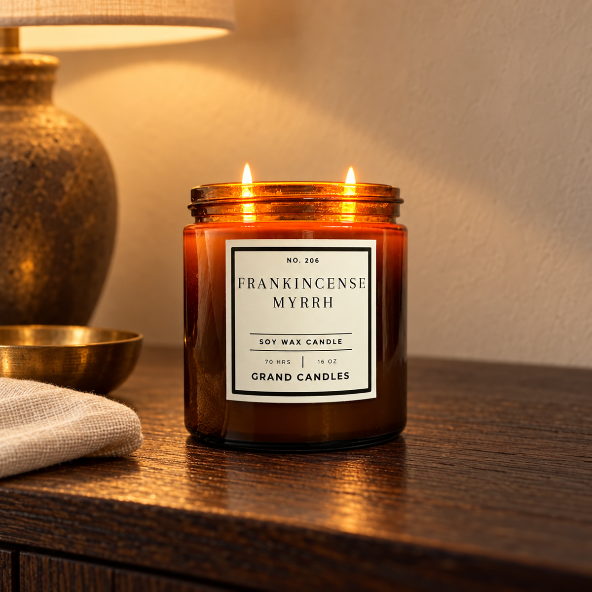 Grand Candles frankincense myrrh 16 oz amber candle in a winter home setting